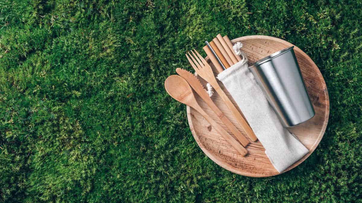 Utensils and plates on grass.