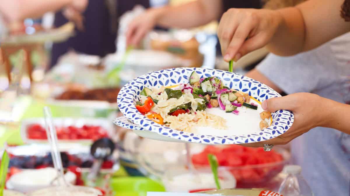 People serving food on plates.