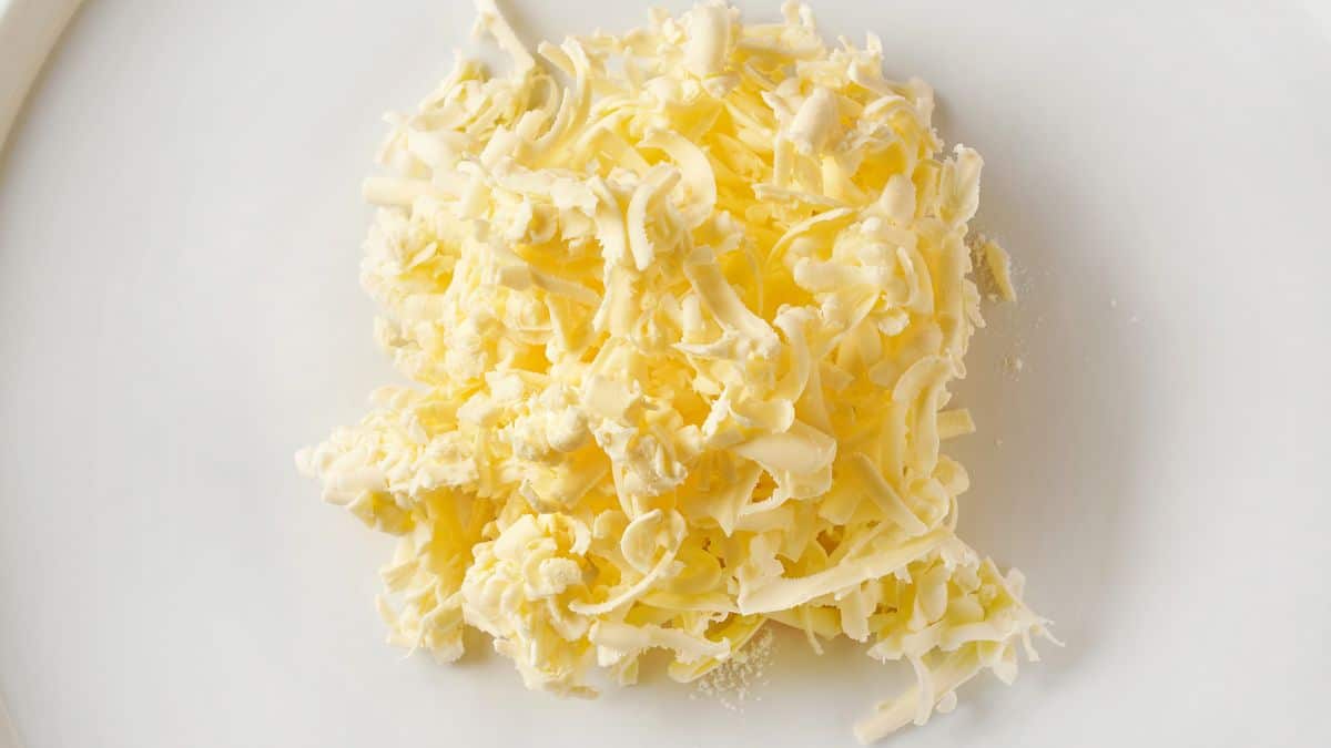 Grated butter on a white plate.