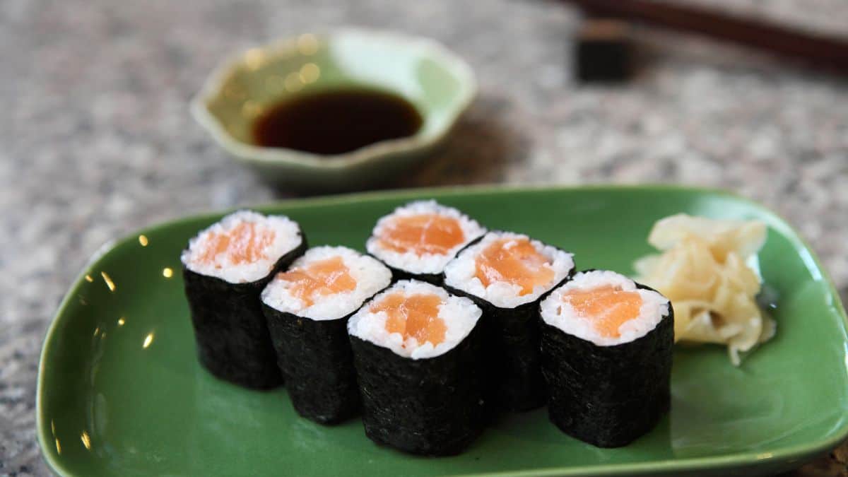 Maki sushi on a green plate.