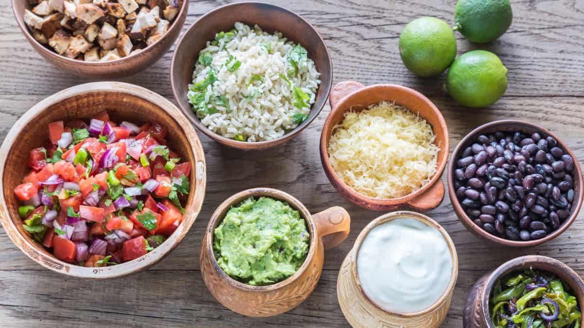 Burrito toppings on a wooden board.