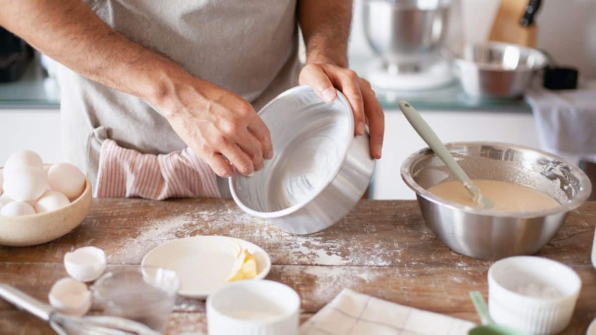 Man greasing a baking pan.