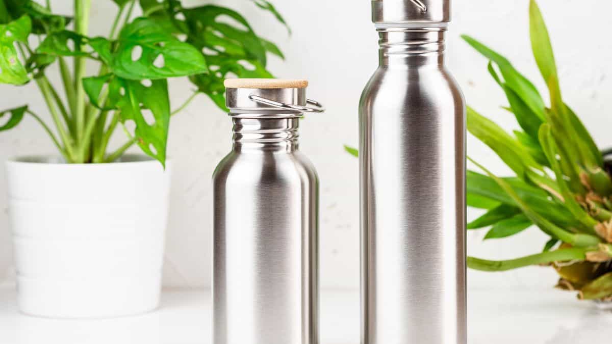 Stainless steel water bottles on a table.