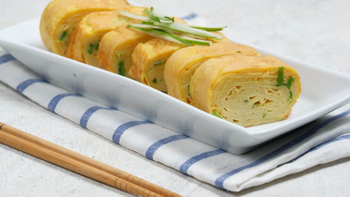 Japanese omelet on a rectangular plate.