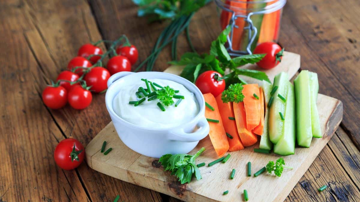 Veggies and dips garnished with herbs.