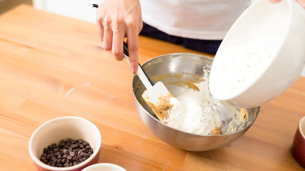 Adding pudding mix into cake batter.