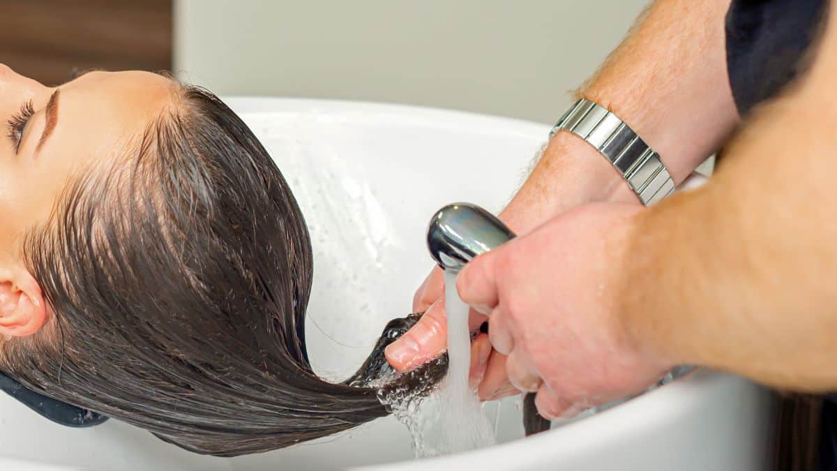 Woman rinsing hair.