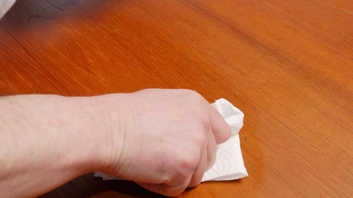 Person polishing furniture.