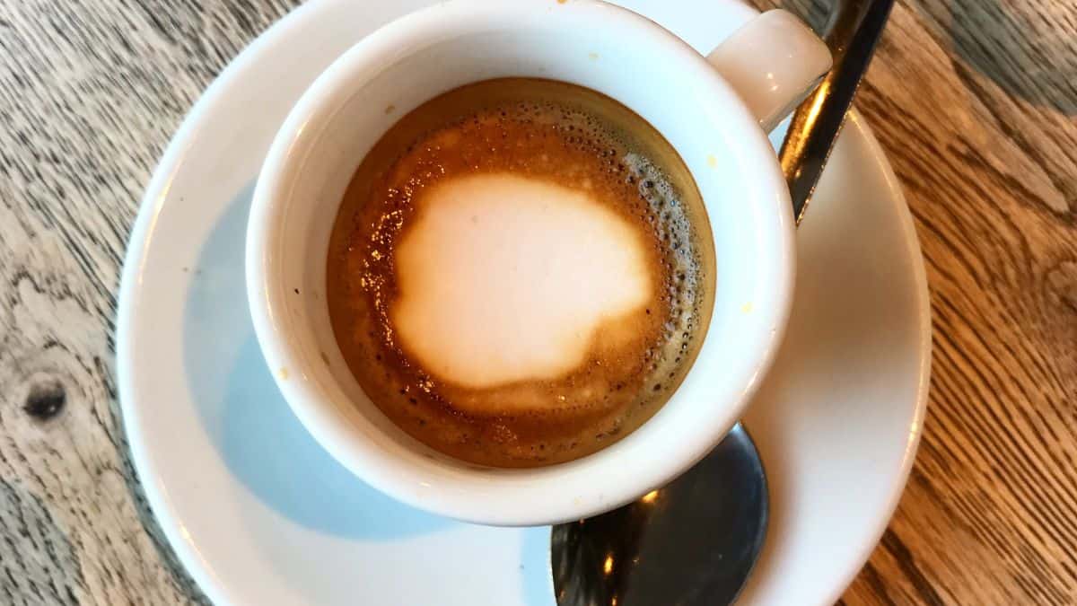 Macchiato cup with a spoon.