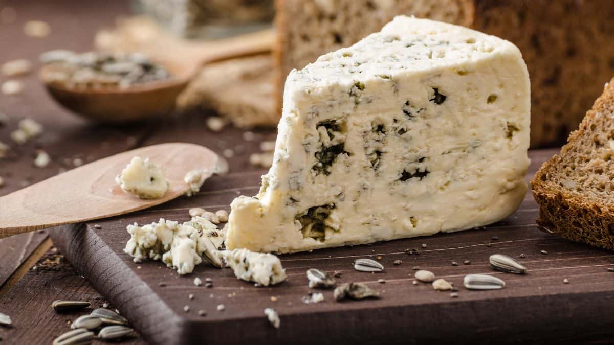 Blue cheese on a wooden board.