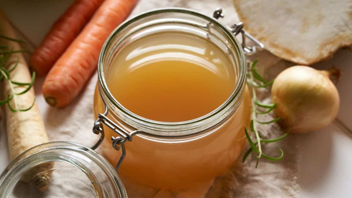 Vegetable broth in a glass jar.