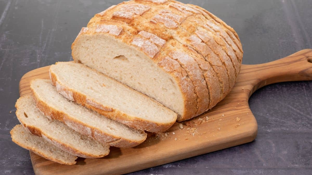 Bread cut into slices on a wooden board.