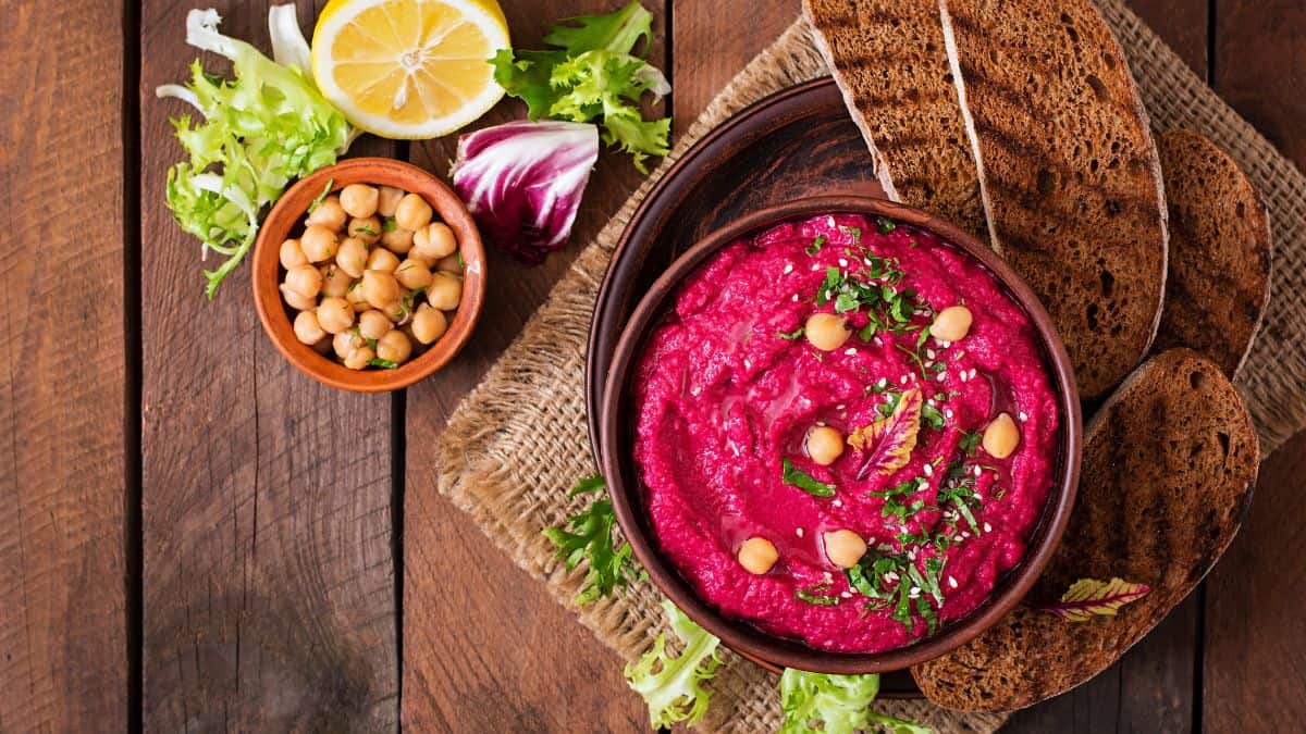 Beetroot hummus in a browl bowl.