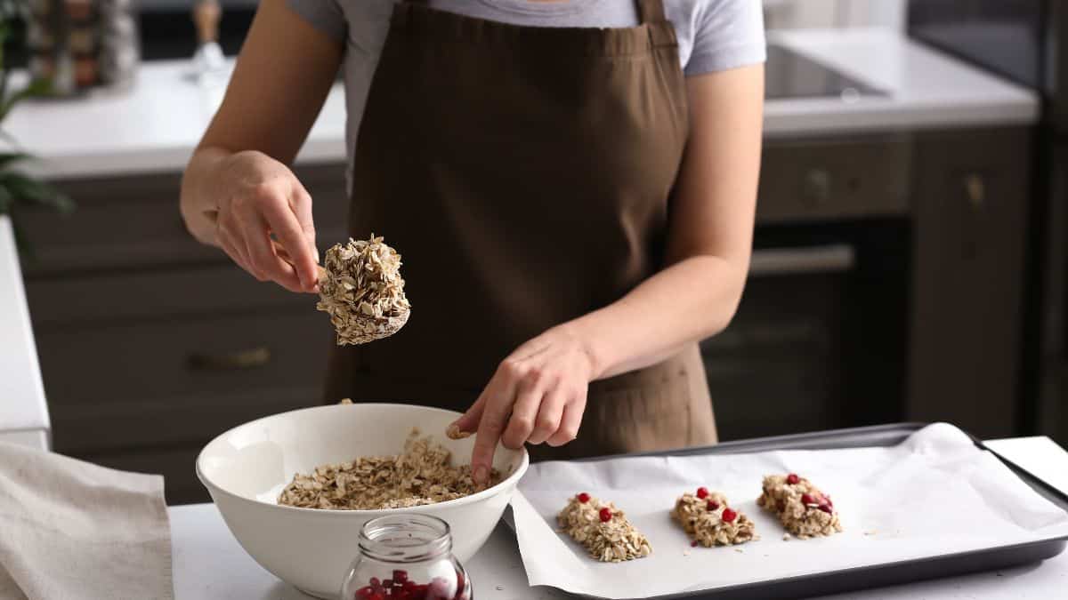 A woman making granola bars.