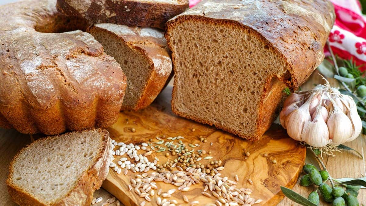 Sliced spelt bread on a wooden board.