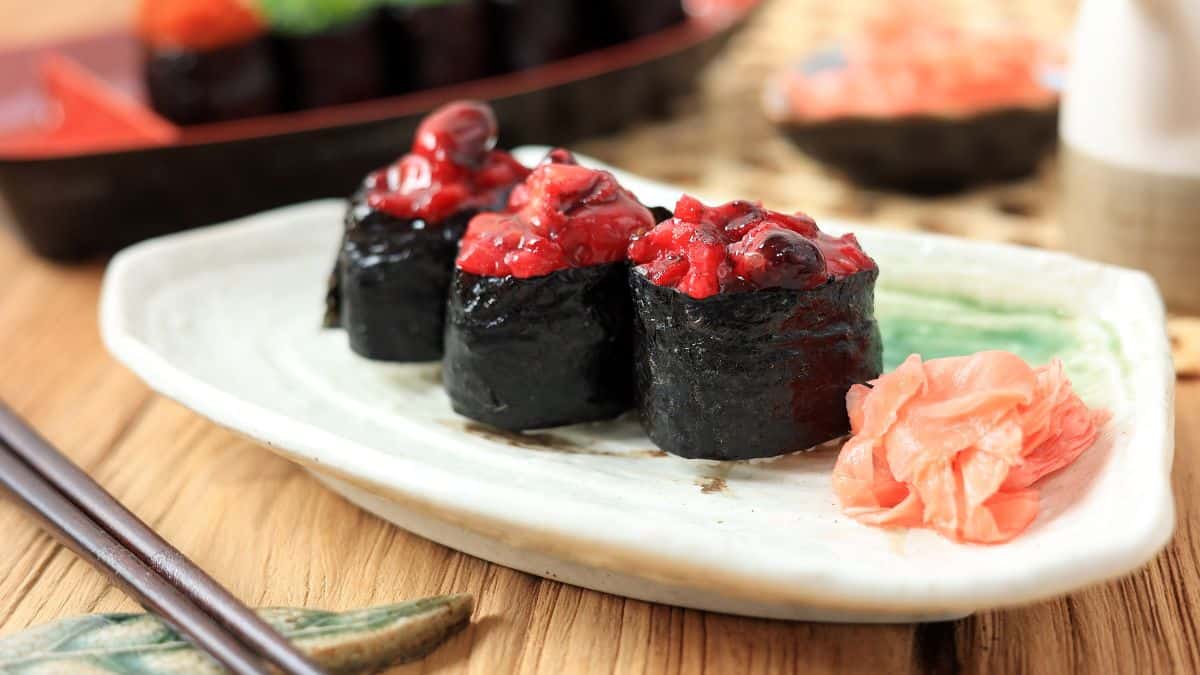 Gunkan sushi on a white plate.