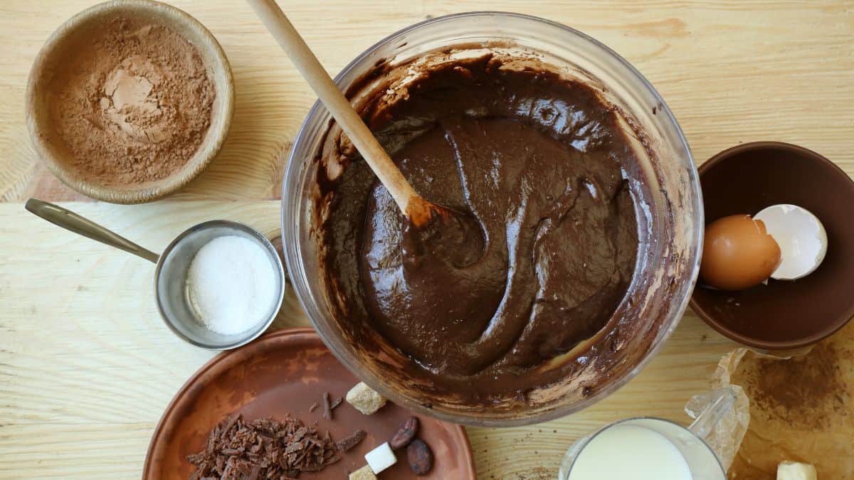 Mixing coffee into chocolate cake batter.