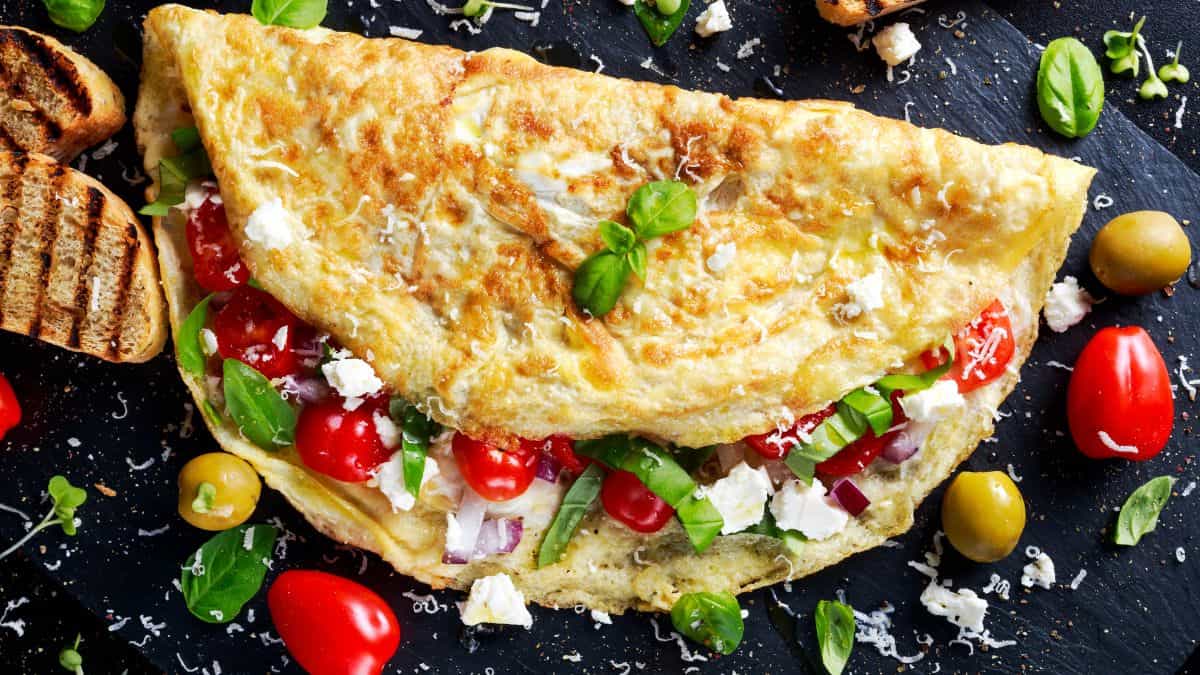 Greek omelet on a black plate.