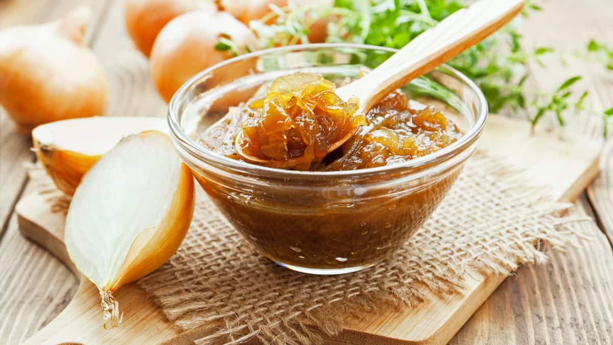 Onion jam in a bowl with spoon inside.