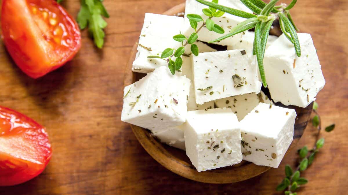 Cubes of feta cheese in a wooden bowl.