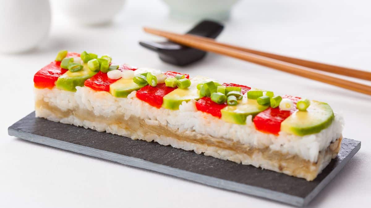 Oshizushi or pressed sushi on a rectangular plate.