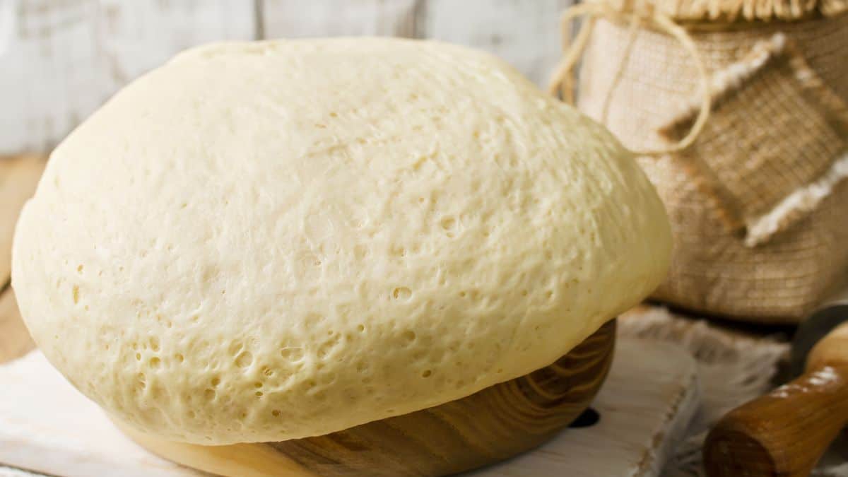 Proofed dough on a wooden surface.