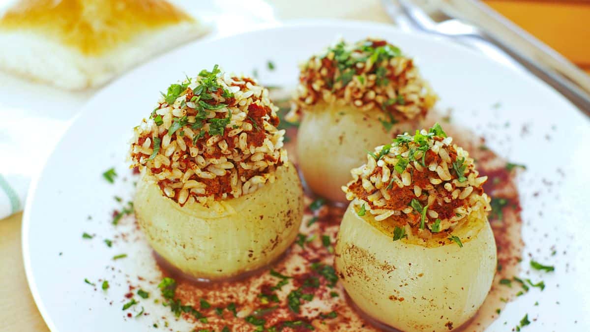 Stuffed onions on a white plate.