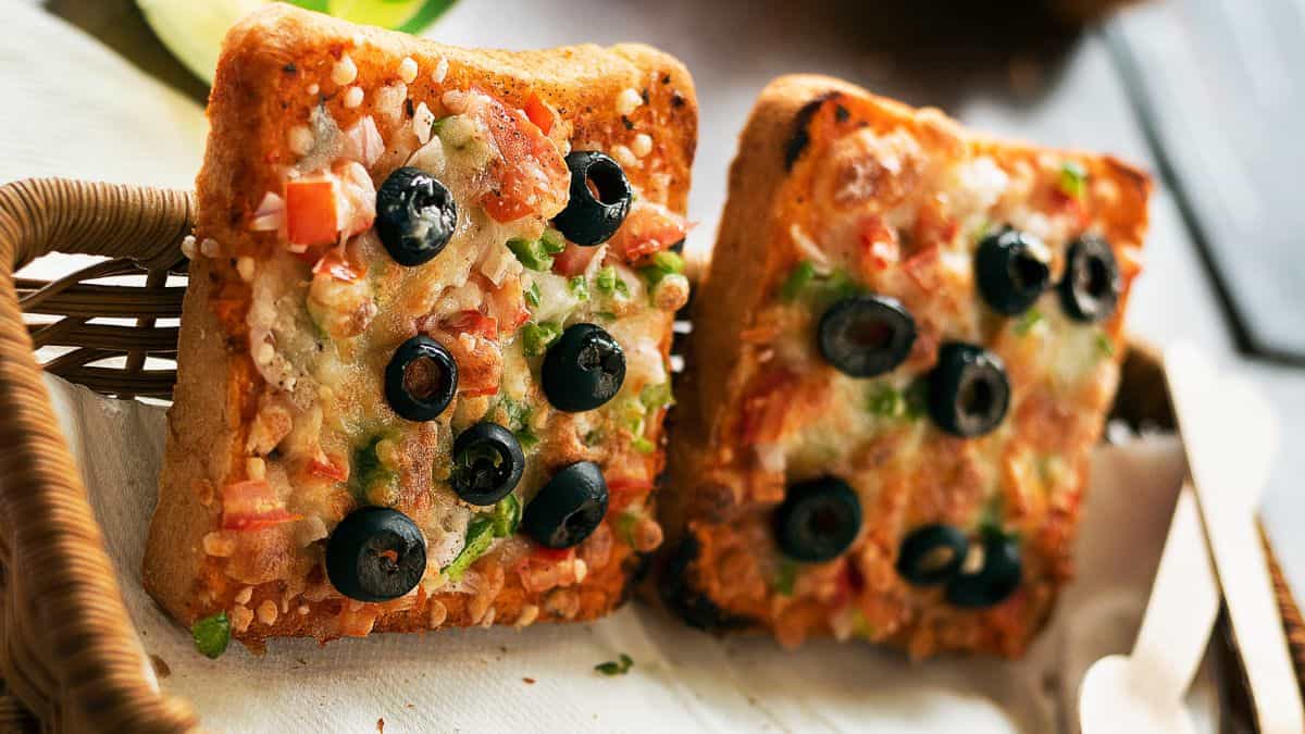 Two pieces of bread pizza in a small basket.