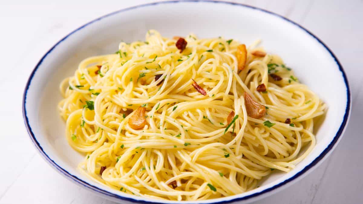 Aglio e olio pasta on a white plate.