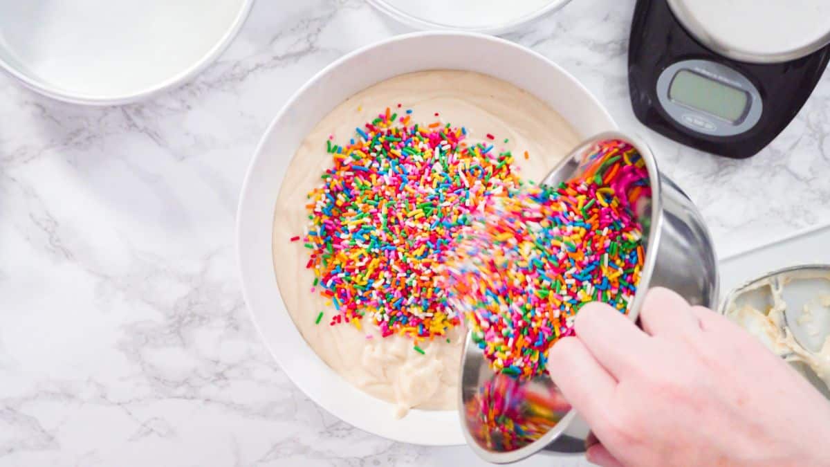 Adding sprinkles into cake batter.