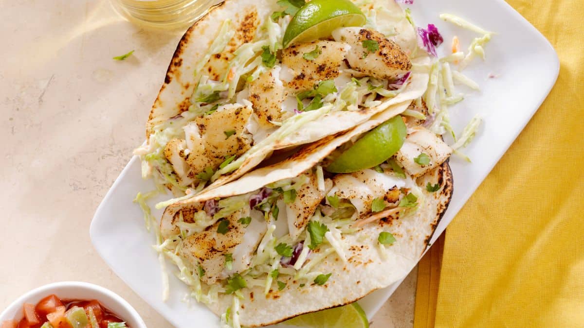 Fish tacos on a white board.