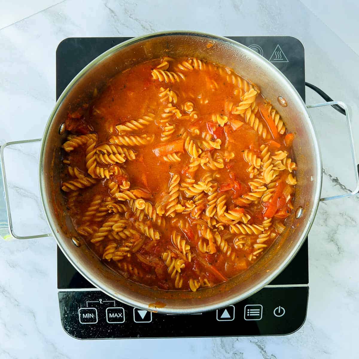 Chickpea pasta cooked in the sauce and chicken broth.