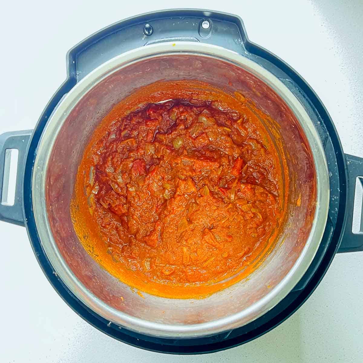 Cooked onion, tomato, and spices in Instant Pot.