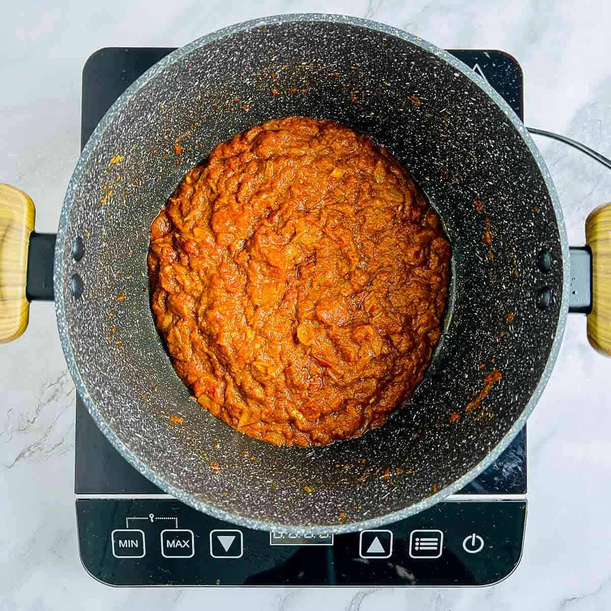 Cooked tomato and spices in the pot.