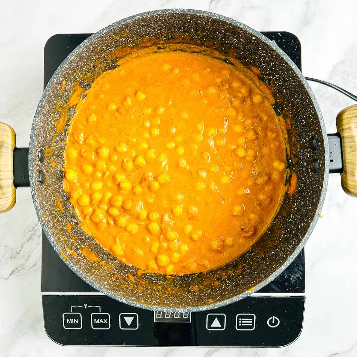 Chickpea mango curry simmered in a pot.