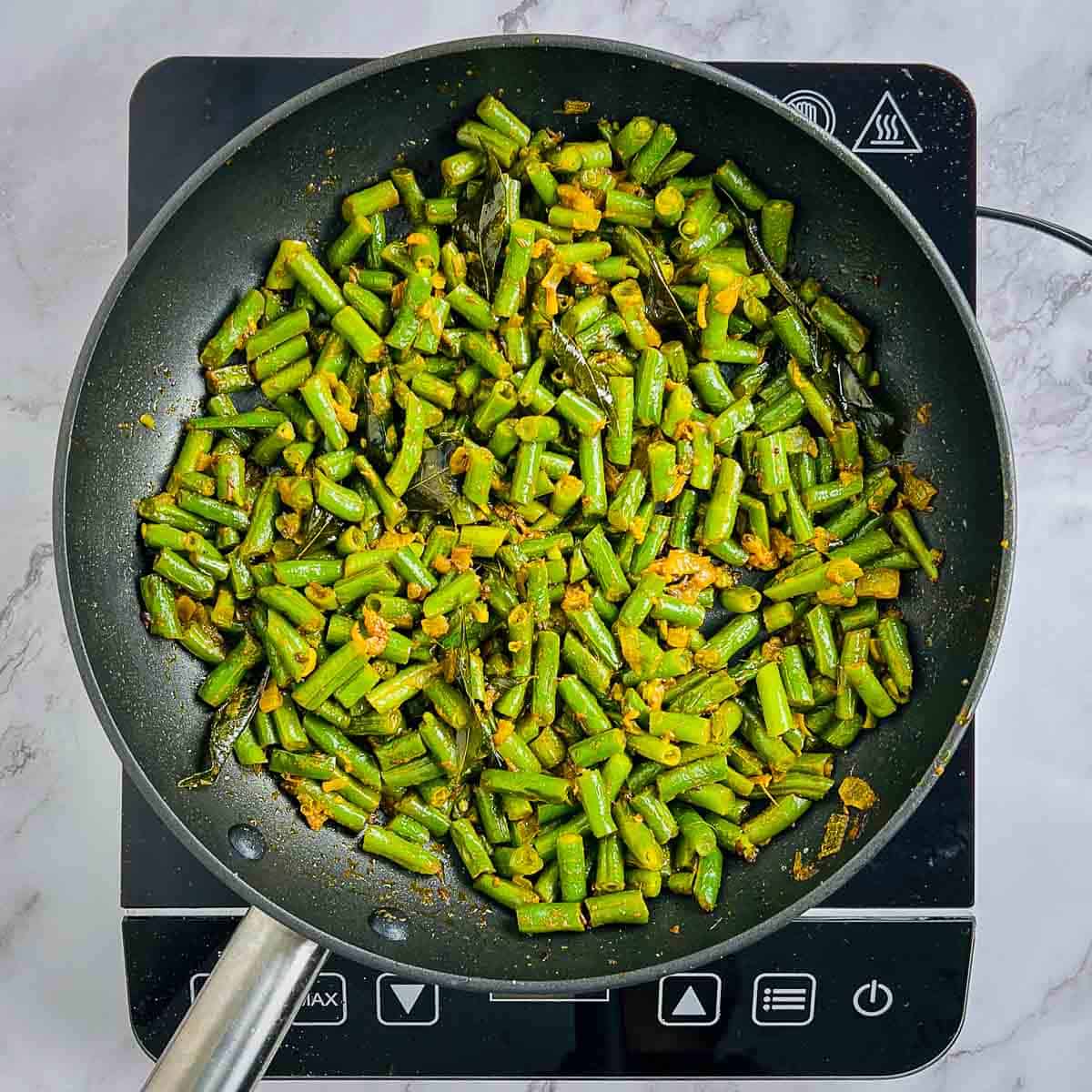 Green beans and spices cooked in onion base.