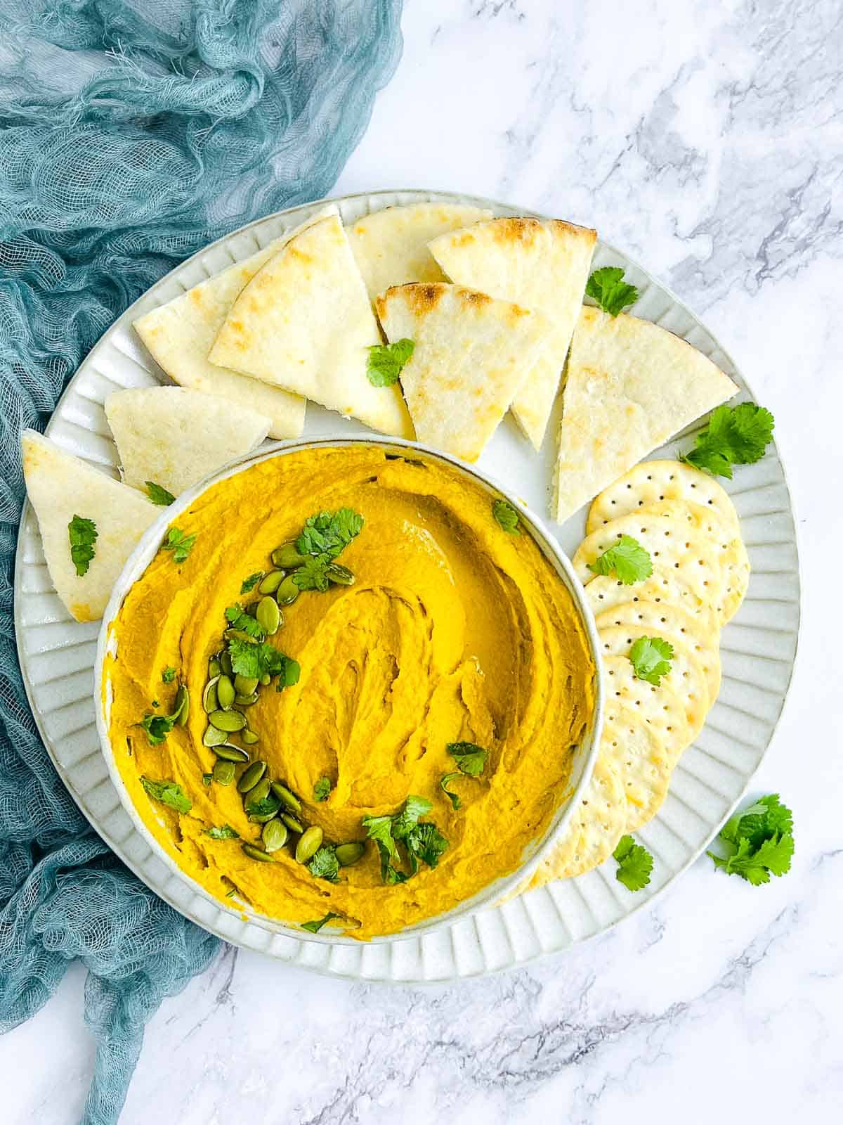 Pumpkin black garlic hummus served with pita bread and crackers.