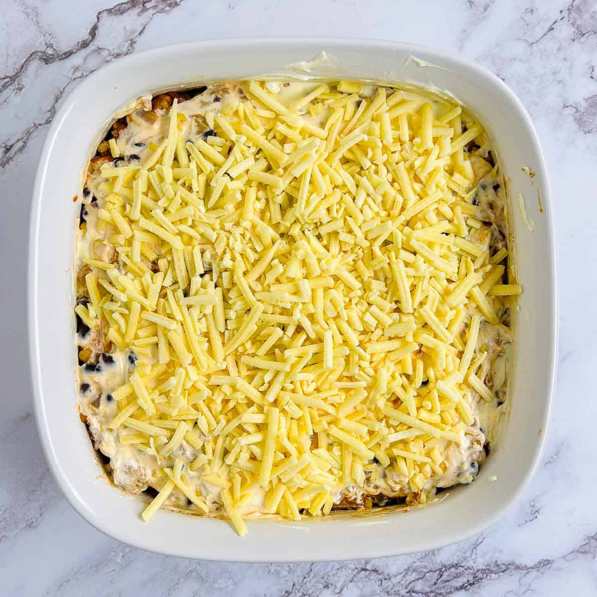 Sour cream and cheese topping in the casserole dish.