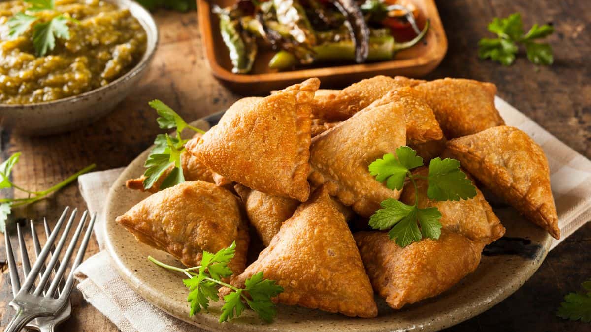 Fried samosas on a plate.