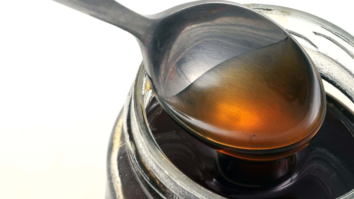 Honey vinegar bottle with a spoon.