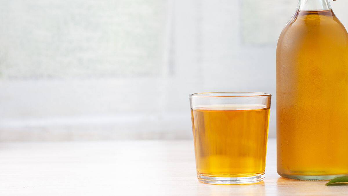 Beer vinegar in a glass and bottle.