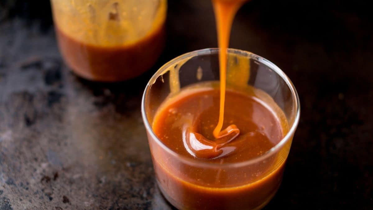 Caramel being poured into a jar.