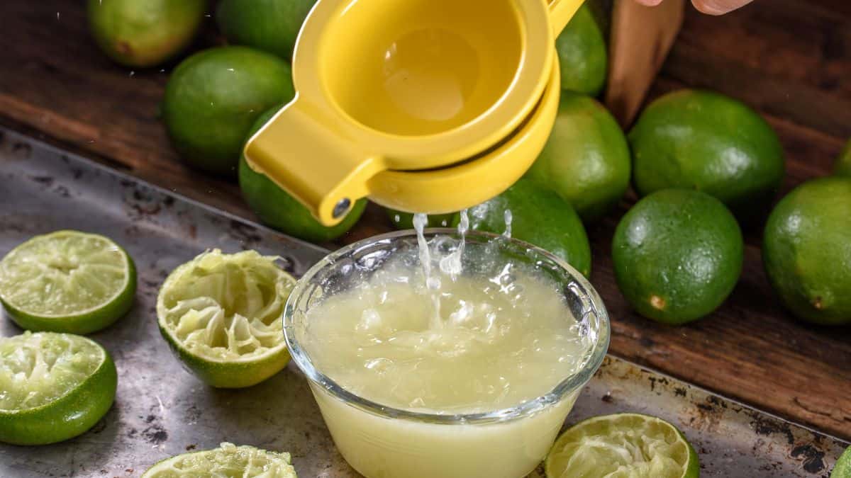 Person squeezing lemon juice into a bowl.