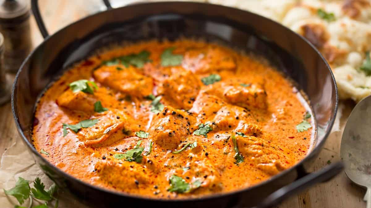 Butter chicken served with naan.