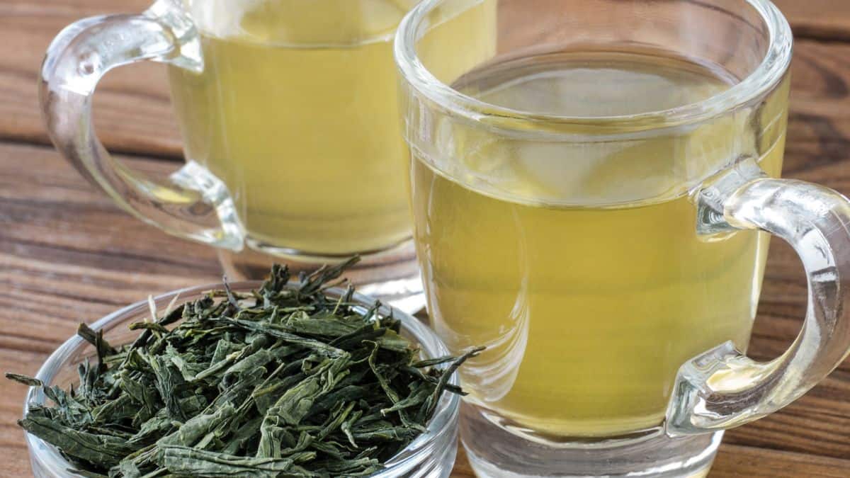 Japanese sencha cups on a wooden surface.