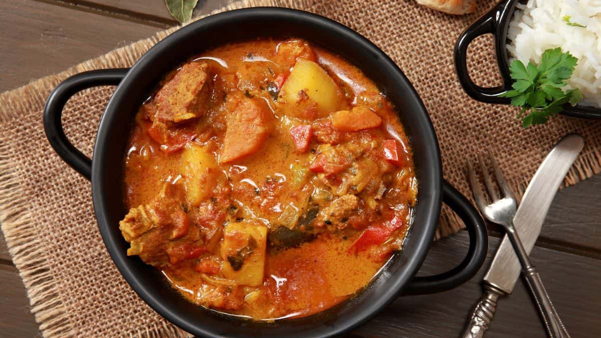 Rogan josh in a black bowl.