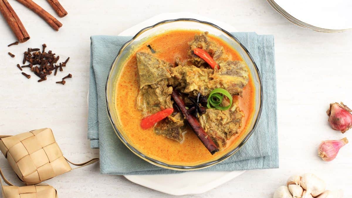 Gulai curry in a bowl placed on a white surface.