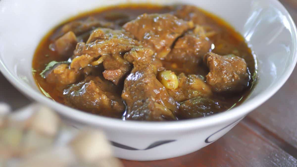 Wet thar hinn curry in a white bowl.