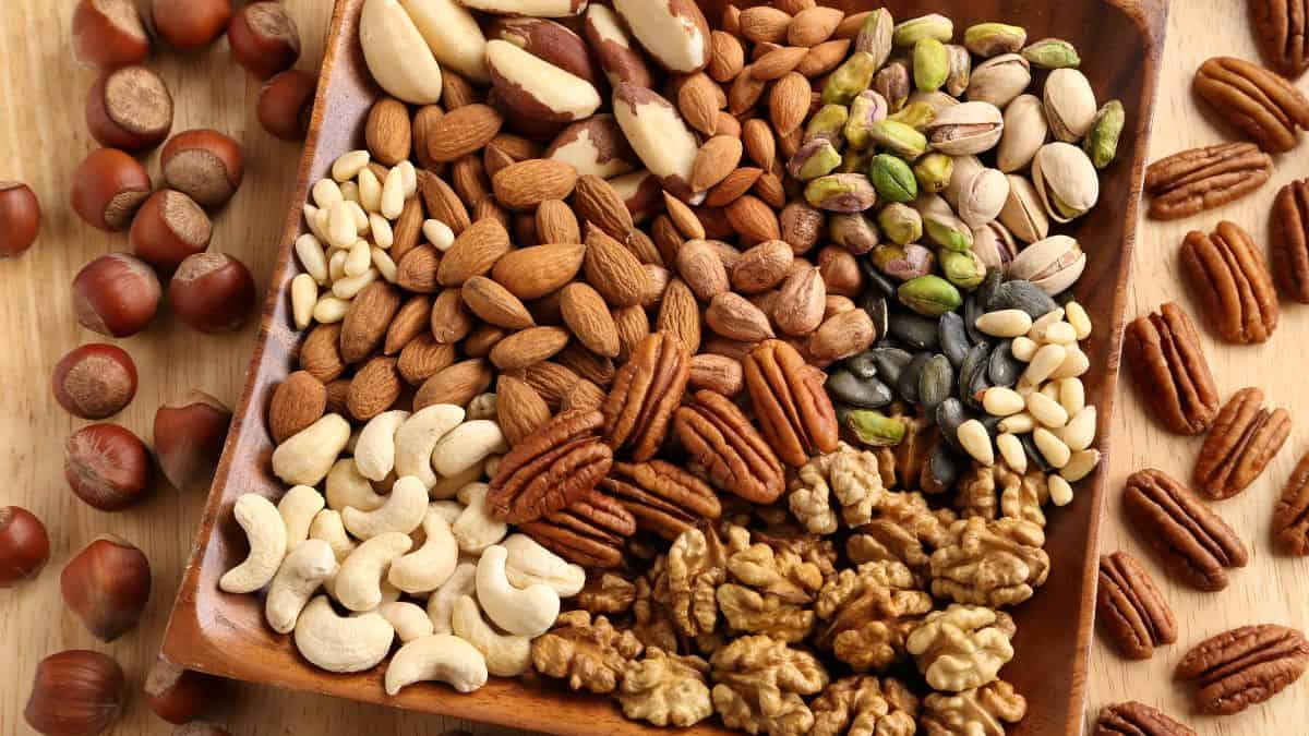 Various nuts kept on a wooden board.