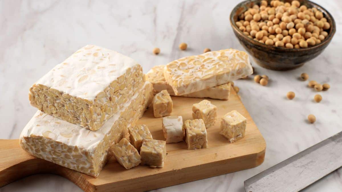 Blocks of tempeh on a wooden board.